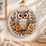 Owl among autumn blooms embroidery hoop wall art displayed as warm and cozy handmade home decor