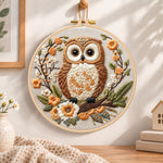 Owl on blossom branch embroidery hoop wall art displayed as warm and cozy handmade home decor