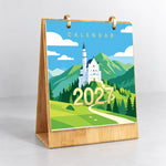 Iconic Landmarks Paint by Numbers Calendar displayed upright on a wooden stand with a scenic castle illustration