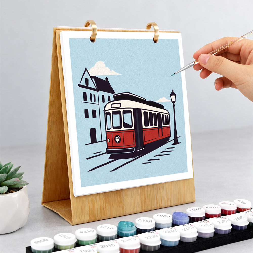 Hand painting a vintage red tram illustration on the On the Move Paint by Numbers Desk Calendar