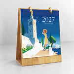 Scenic Getaways Paint by Numbers Calendar displayed upright on a wooden desk stand with illustrated travel cover