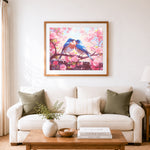 Finished pair of bluebirds on cherry blooms cross stitch artwork displayed as home decor