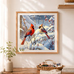 Finished pair of cardinals in winter scene cross stitch artwork displayed as home decor