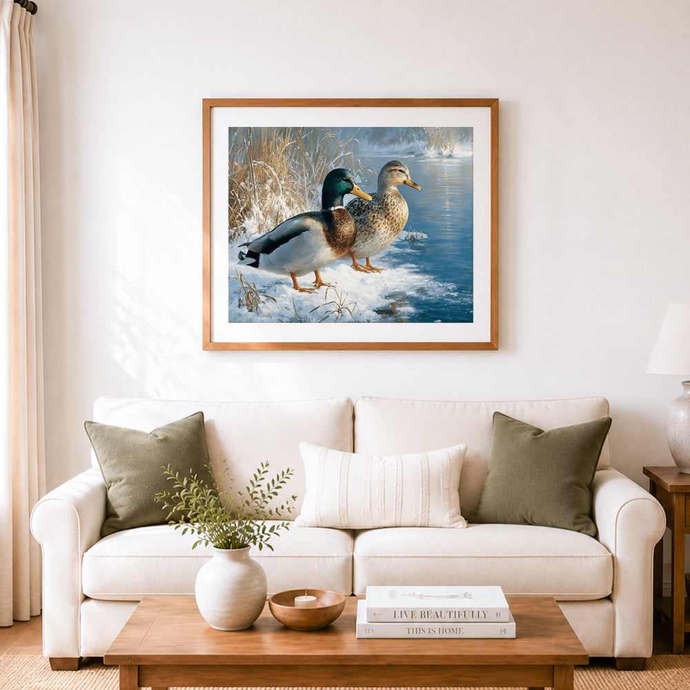 Finished pair of mallard ducks on snowy riverbank cross stitch artwork displayed as home decor