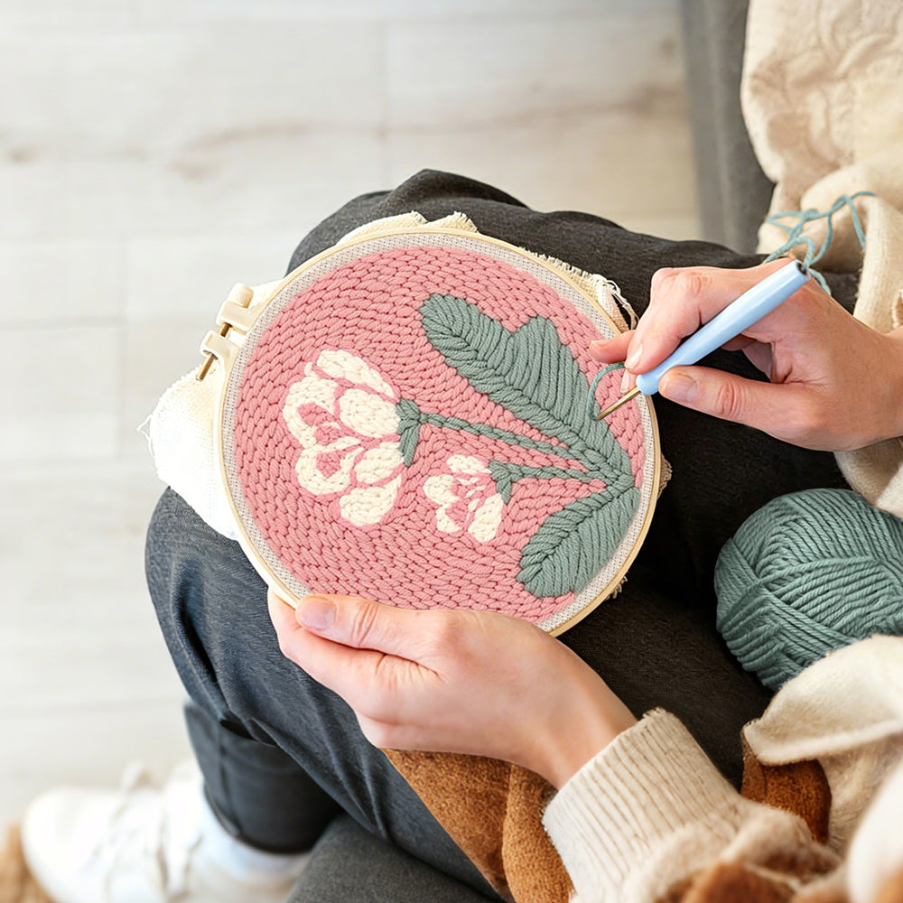 Creating handmade pale pink background with white flowers punch needle artwork