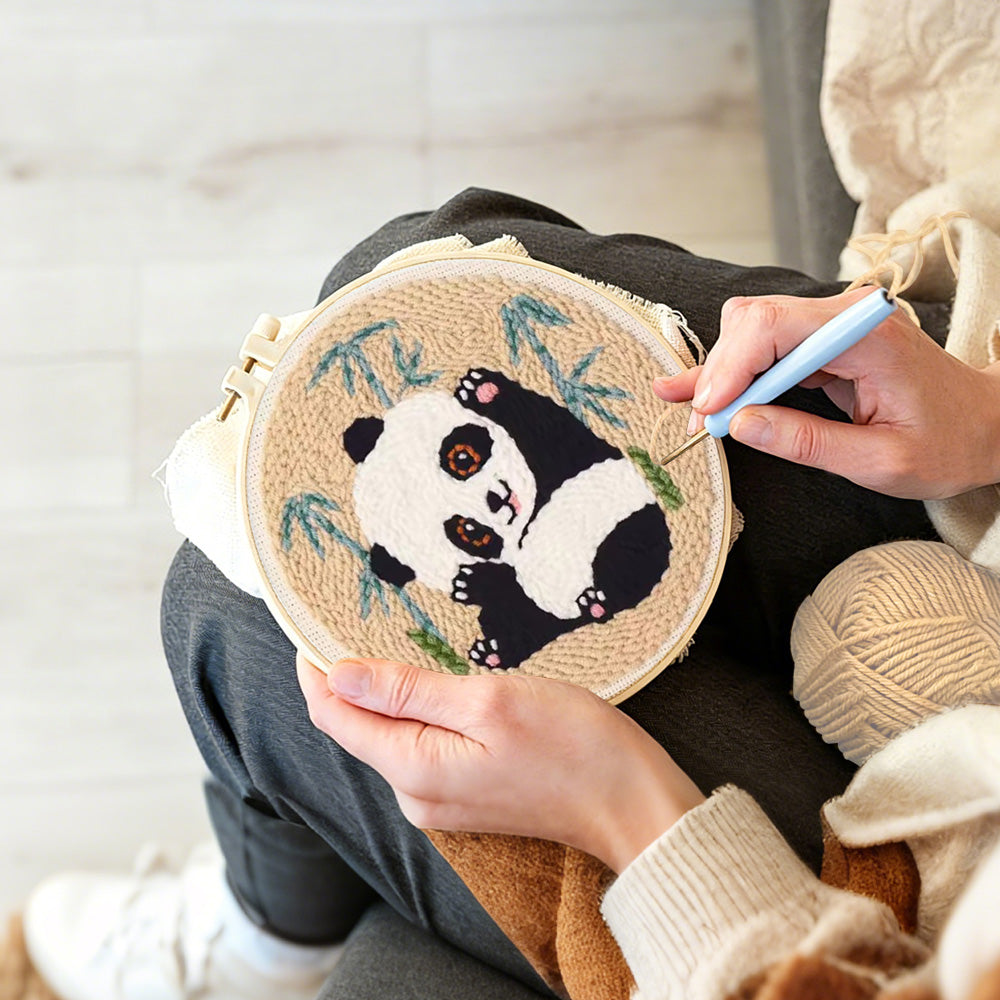 Creating handmade panda stretching punch needle artwork