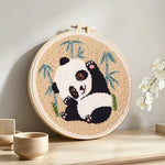 Panda stretching punch needle artwork displayed on a table