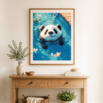 Finished panda swimming with koi cross stitch artwork displayed as home decor