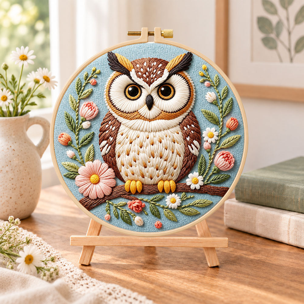 Pastel floral owl embroidery kit finished hoop displayed on a wooden stand as cozy tabletop decor