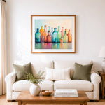 Finished pastel glass bottle glow cross stitch artwork displayed as home decor