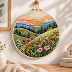 Pastel mountain flower hills embroidery hoop wall art displayed as warm and cozy handmade home decor