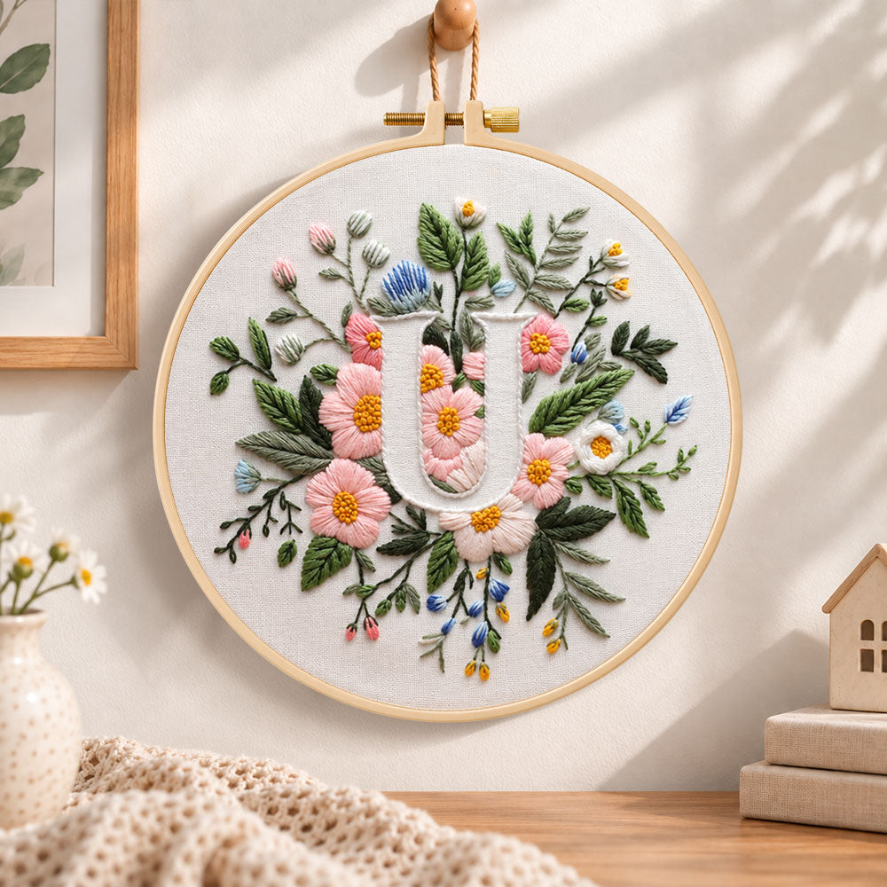 Pastel pink blooms and letter u embroidery hoop wall art displayed as warm and cozy handmade home decor