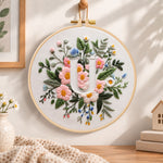 Pastel pink blooms and letter u embroidery hoop wall art displayed as warm and cozy handmade home decor