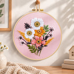 Pastel pink florals embroidery hoop wall art displayed as warm and cozy handmade home decor