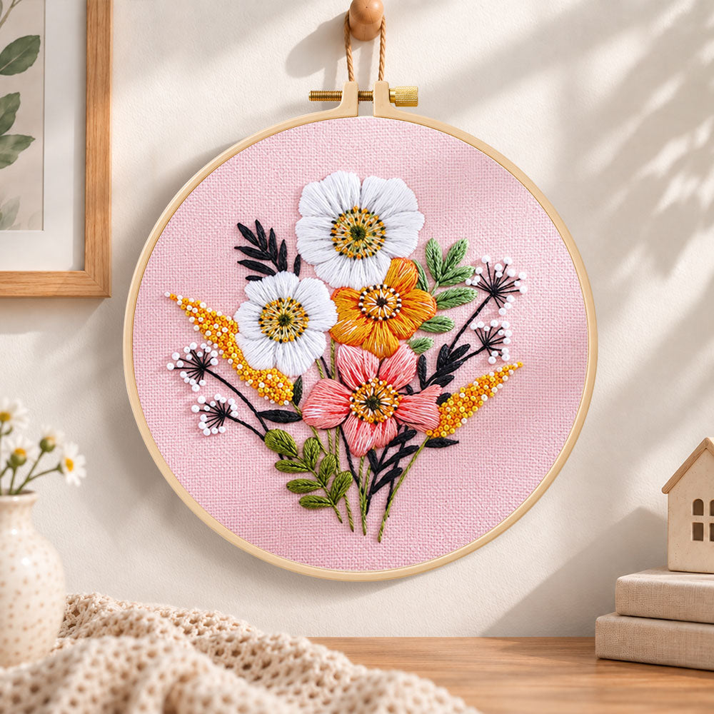 Pastel pink florals embroidery hoop wall art displayed as warm and cozy handmade home decor
