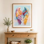 Finished pastel rainbow angel wings cross stitch artwork displayed as home decor