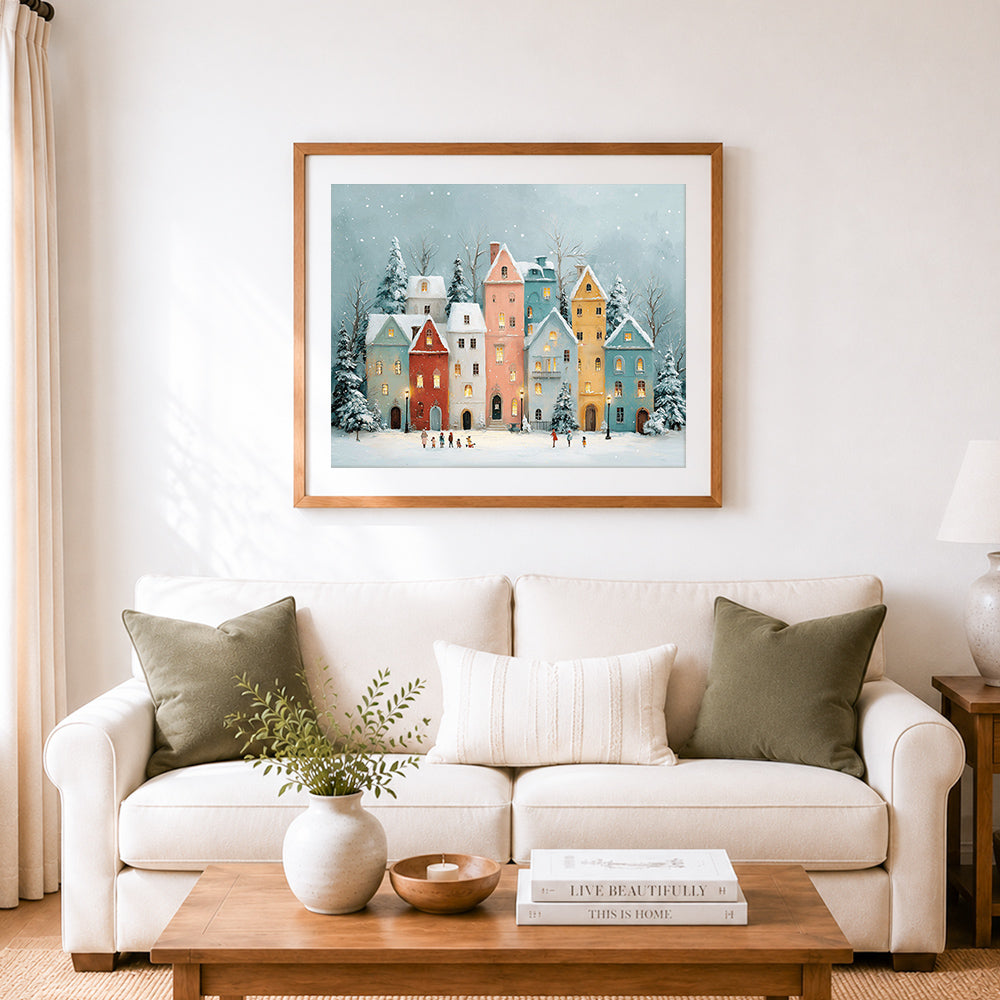 Finished pastel row houses in the snow cross stitch artwork displayed as home decor