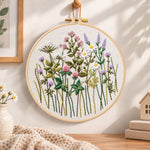 Pastel wildflower hand embroidery hoop wall art displayed as warm and cozy handmade home decor