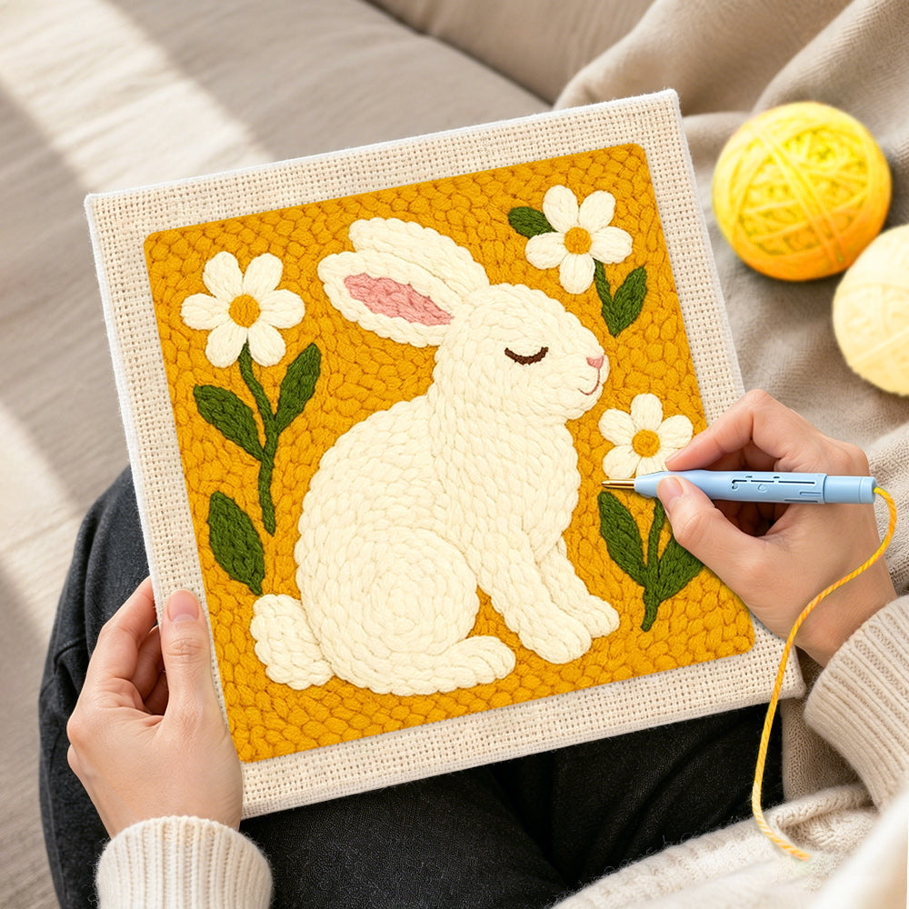 Creating handmade peaceful white bunny with daisies punch needle artwork