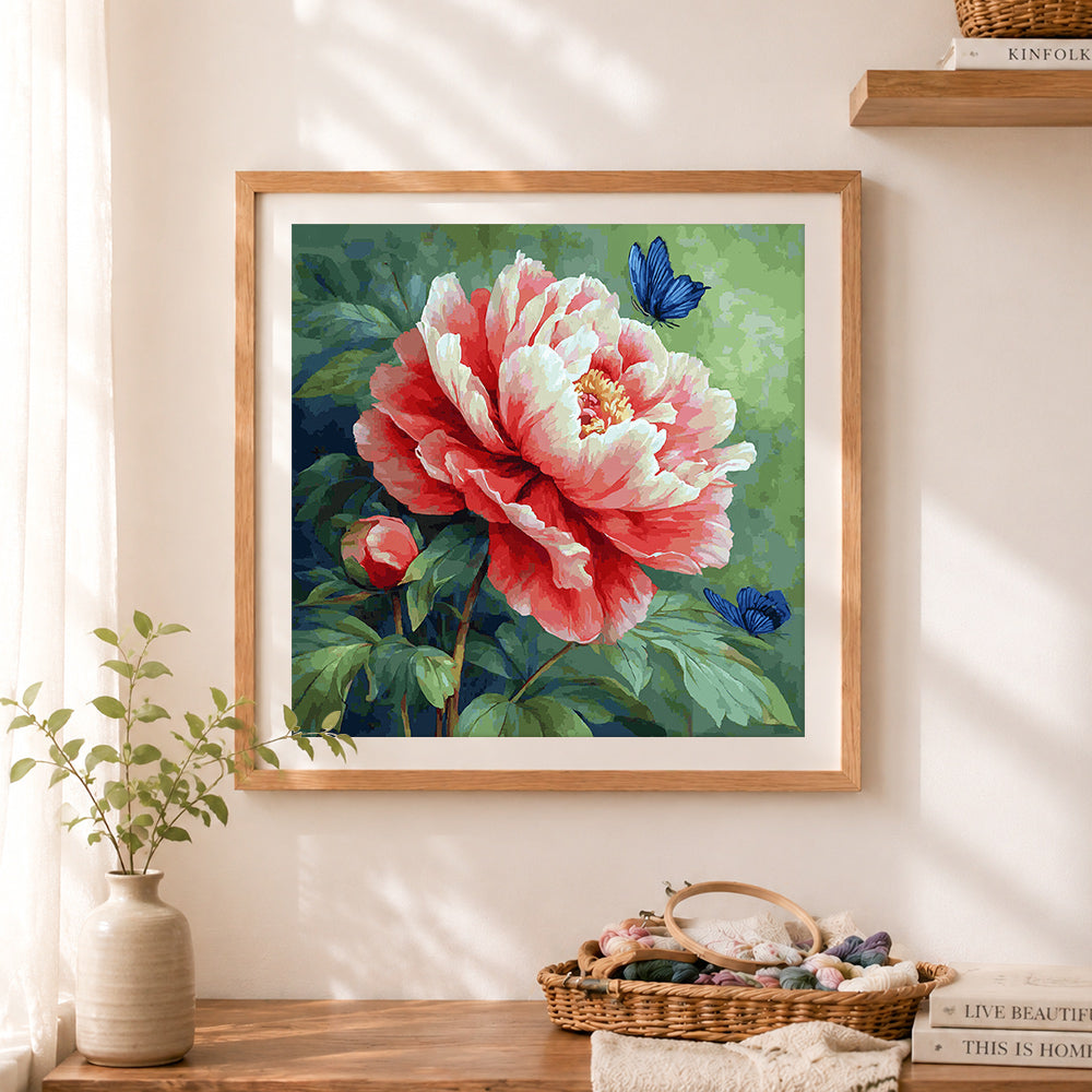 Finished peony and blue butterflies cross stitch artwork displayed as home decor