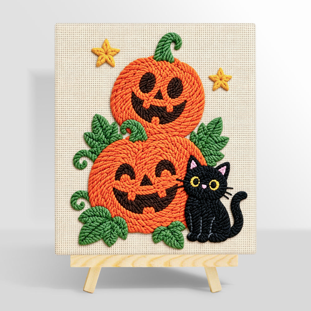 Pile of pumpkins with black cat punch needle kit for beginners