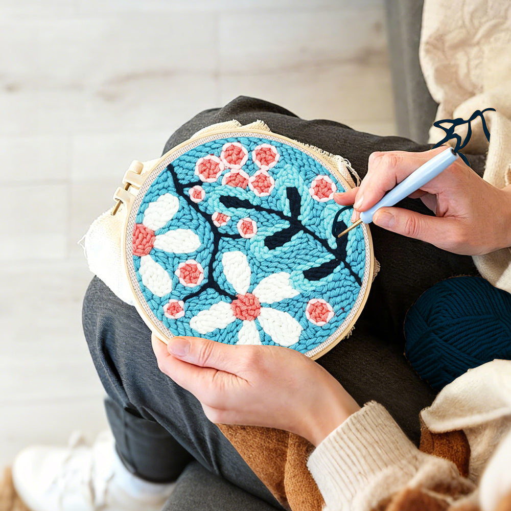 Creating handmade pink and white sakura punch needle artwork