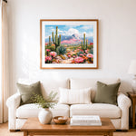 Finished pink blooming cactus in desert cross stitch artwork displayed as home decor
