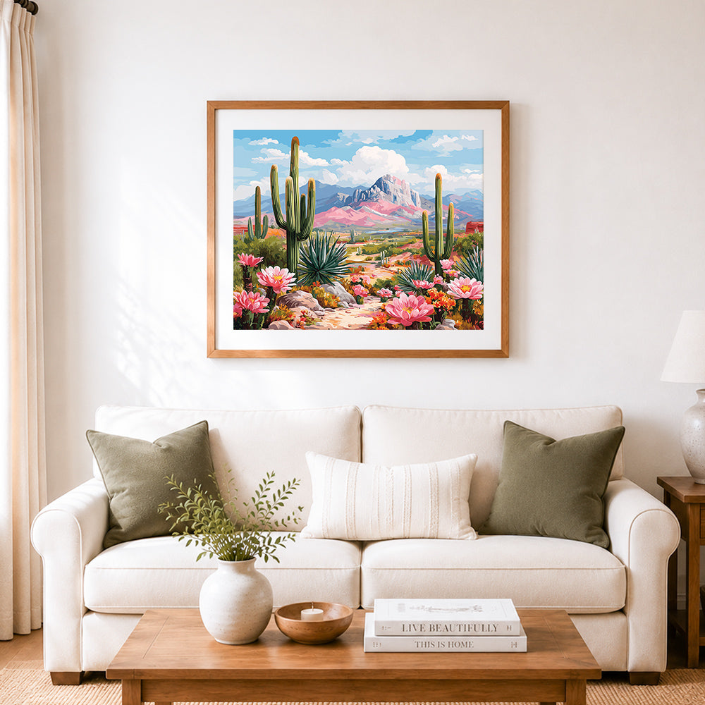 Finished pink blooming cactus in desert cross stitch artwork displayed as home decor