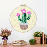 Finished pink blooming cactus artwork displayed on a wall