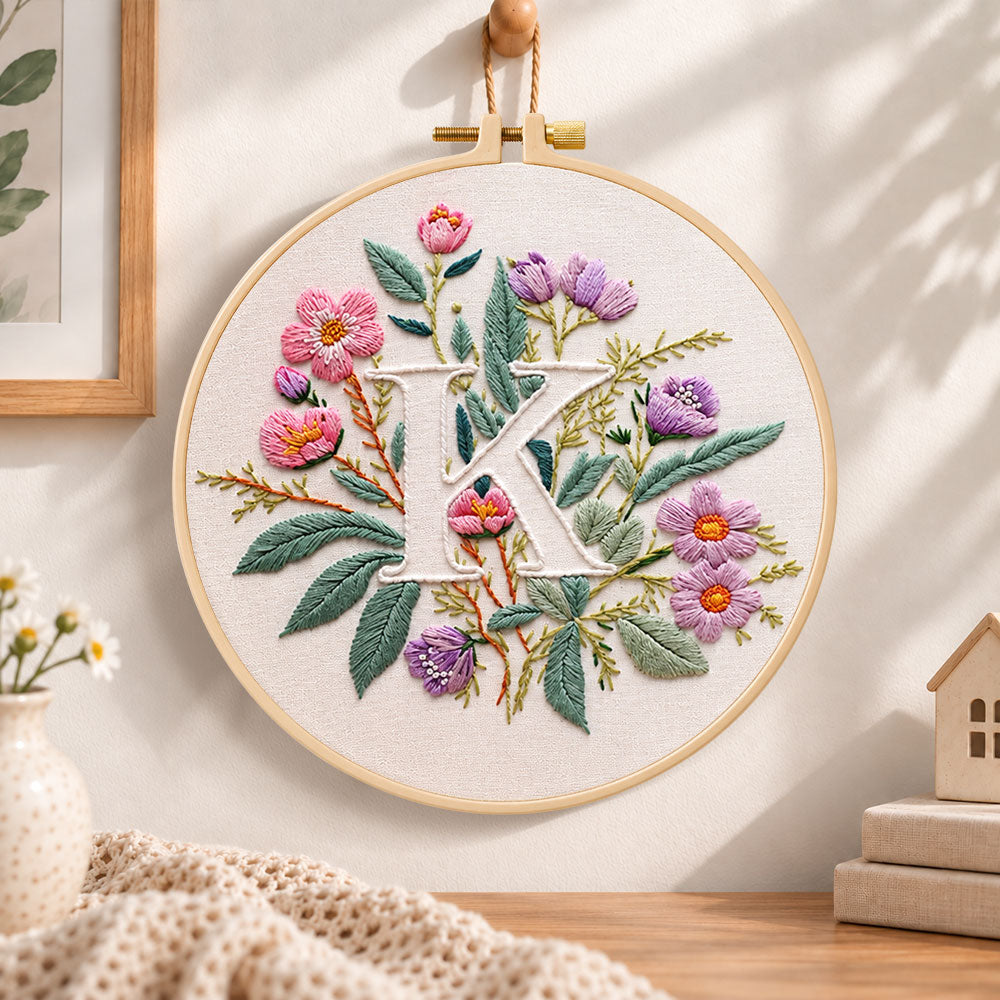Pink blooms and letter k embroidery hoop wall art displayed as warm and cozy handmade home decor