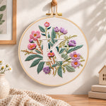 Pink blooms and letter k embroidery hoop wall art displayed as warm and cozy handmade home decor