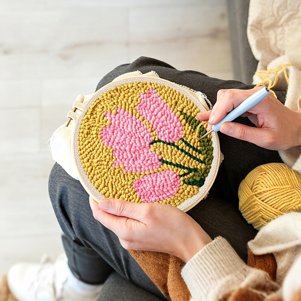 Creating handmade pink blooms on mustard yellow background punch needle artwork
