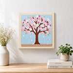 Finished pink cherry blossom tree artwork displayed on a wall