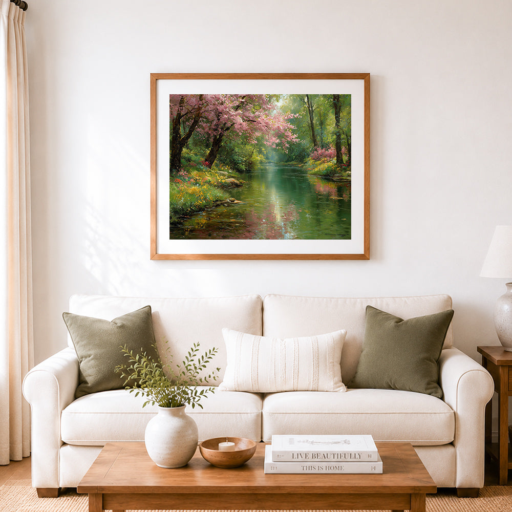 Finished pink cherry blossoms over a peaceful river cross stitch artwork displayed as home decor