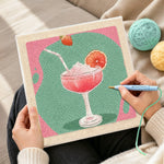 Creating handmade pink cocktail with grapefruit punch needle artwork