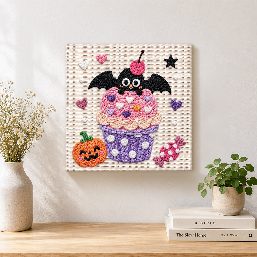 Finished pink cupcake with bat artwork displayed on a wall