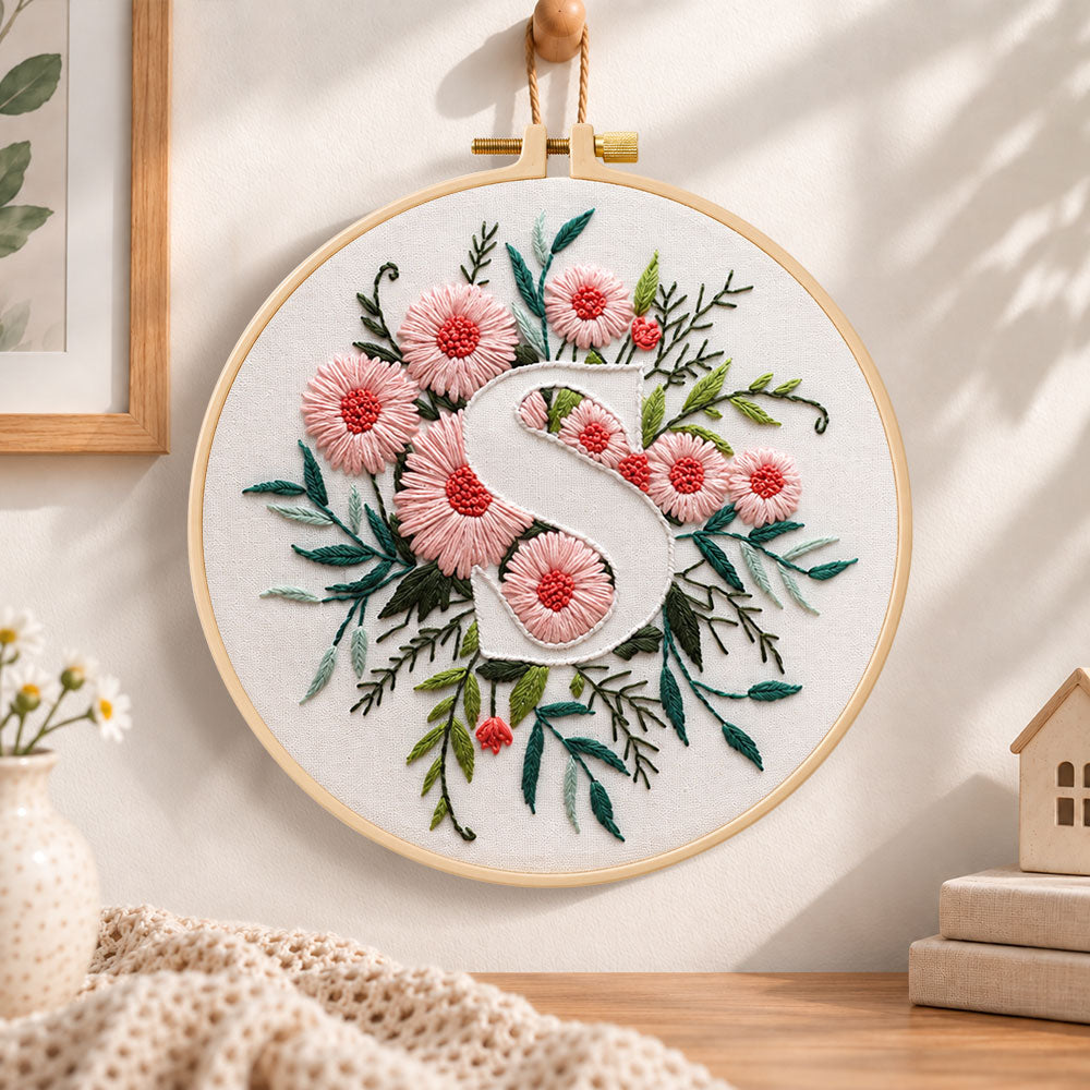 Pink daisy blooms and letter s embroidery hoop wall art displayed as warm and cozy handmade home decor