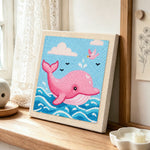 Pink dolphin jumping from waves punch needle artwork displayed on a table