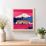 Finished pink dusk temple and snowy mountain artwork displayed on a wall