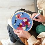 Creating handmade pink flamingo with colorful flowers punch needle artwork