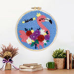 Finished pink flamingo with colorful flowers artwork displayed on a wall