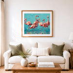 Finished pink flamingos in teal water cross stitch artwork displayed as home decor