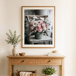Finished pink floral arrangement on wooden chair cross stitch artwork displayed as home decor