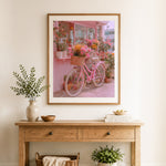 Finished pink floral bicycle cross stitch artwork displayed as home decor