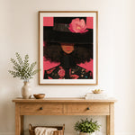 Finished pink floral hat cross stitch artwork displayed as home decor