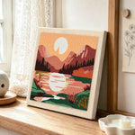 Pink mountain sunrise punch needle artwork displayed on a table