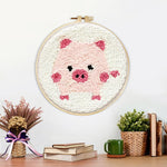 Finished pink piglet artwork displayed on a wall
