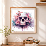 Finished pink watercolor floral skull cross stitch artwork displayed as home decor