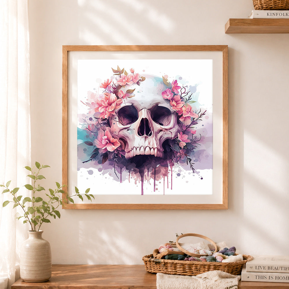Finished pink watercolor floral skull cross stitch artwork displayed as home decor