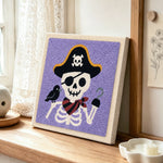Pirate skeleton punch needle artwork displayed on a table